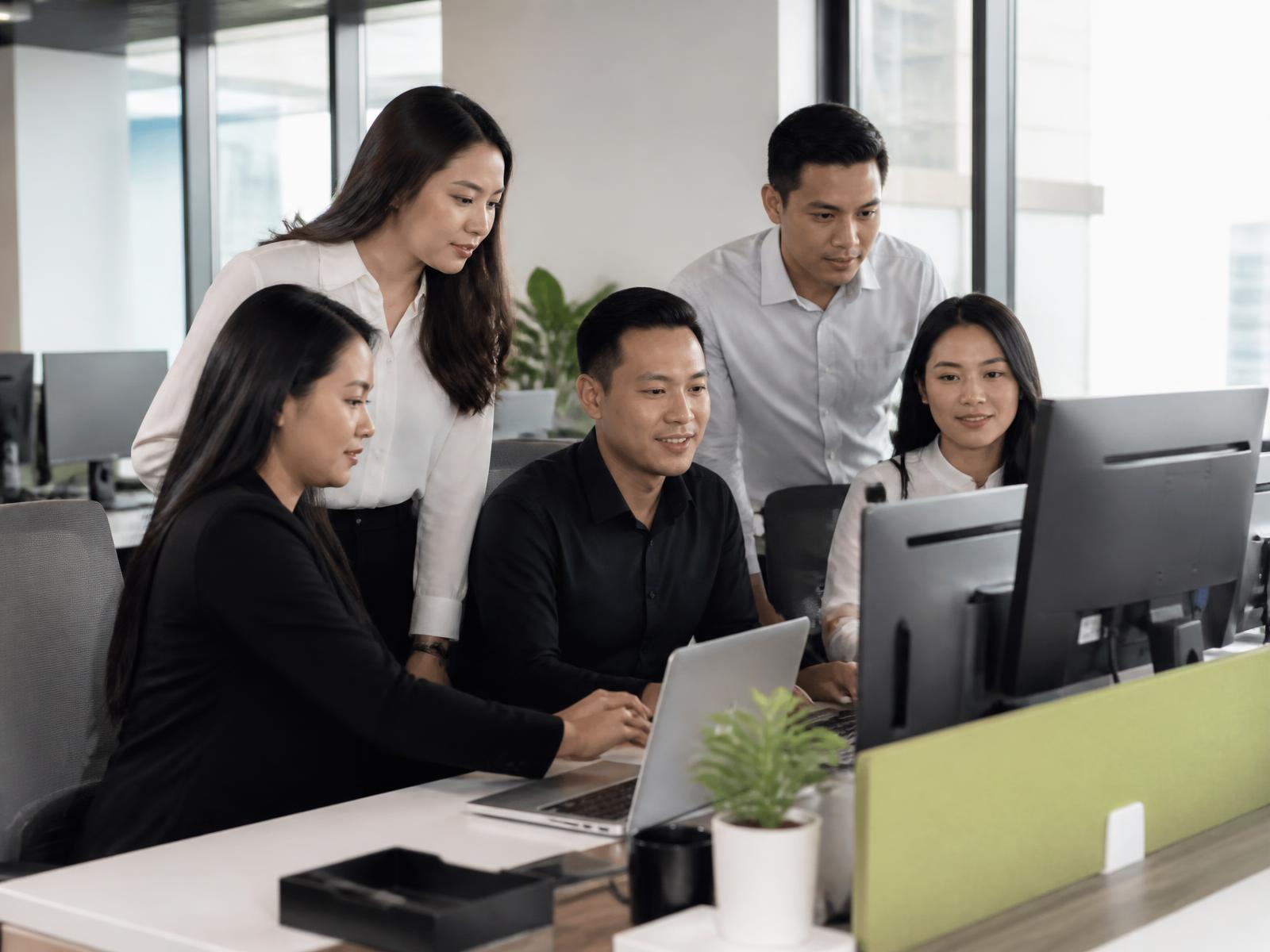 A capable support team collaborating at a modern workstation